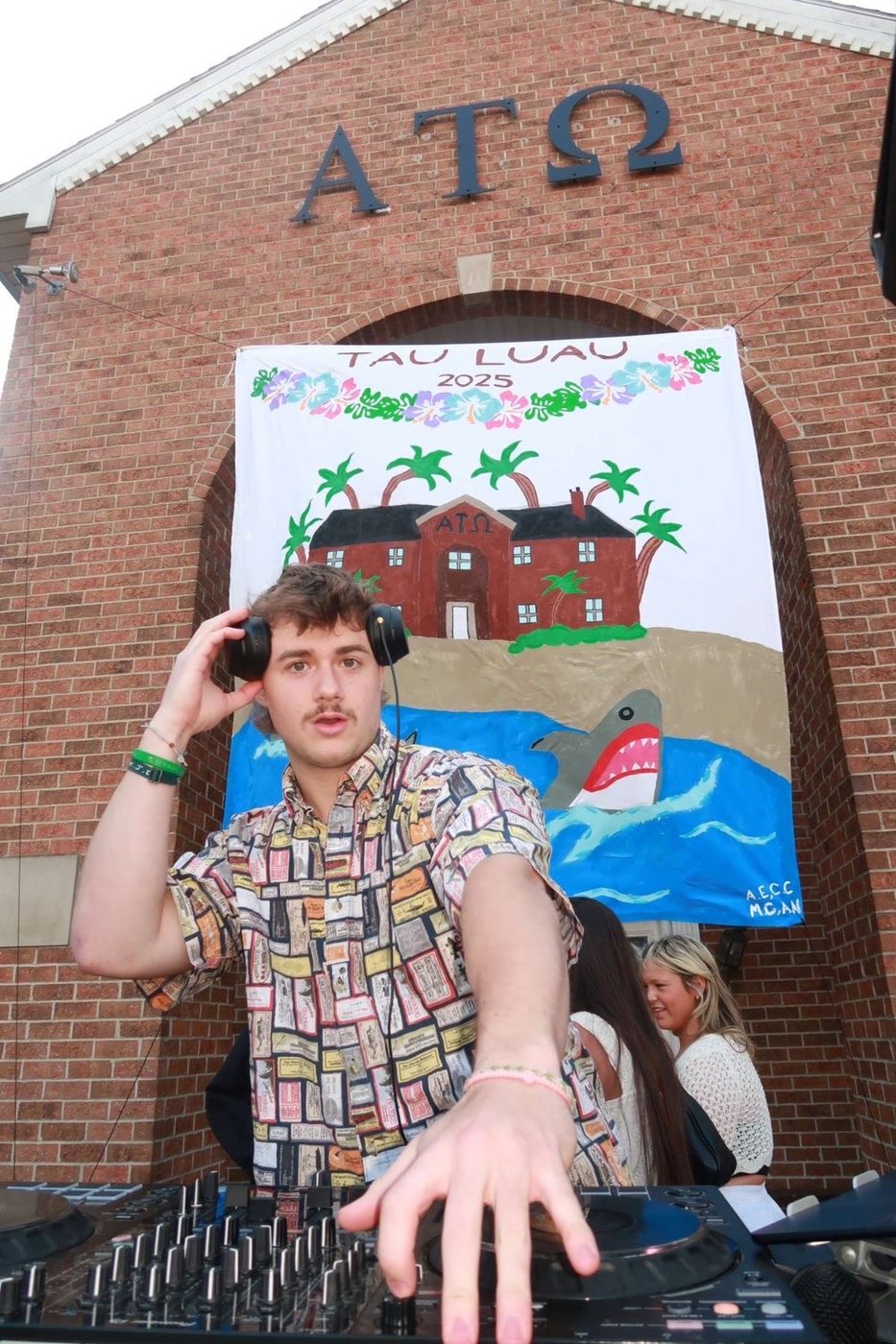 Stoakley reaching across the decks at the Alpha Tau Omega house at GVSU